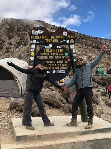 Trekkers resting at Barafu Base Camp before their midnight summit attempt on Mount Kilimanjaro