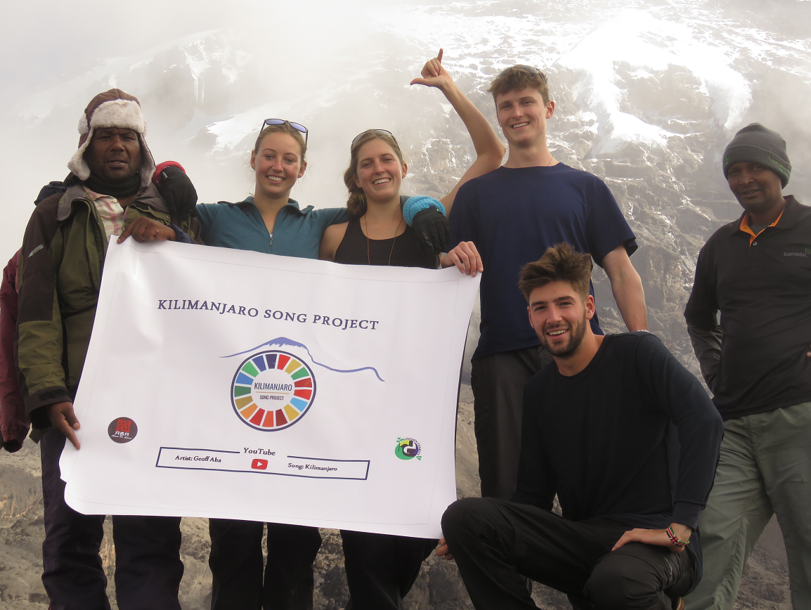 Climbers celebrating a New Year summit at Uhuru Peak